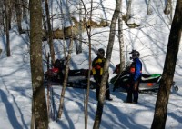 Snowmobilers chatting beside a trail in Jackson County, Wisconsin.